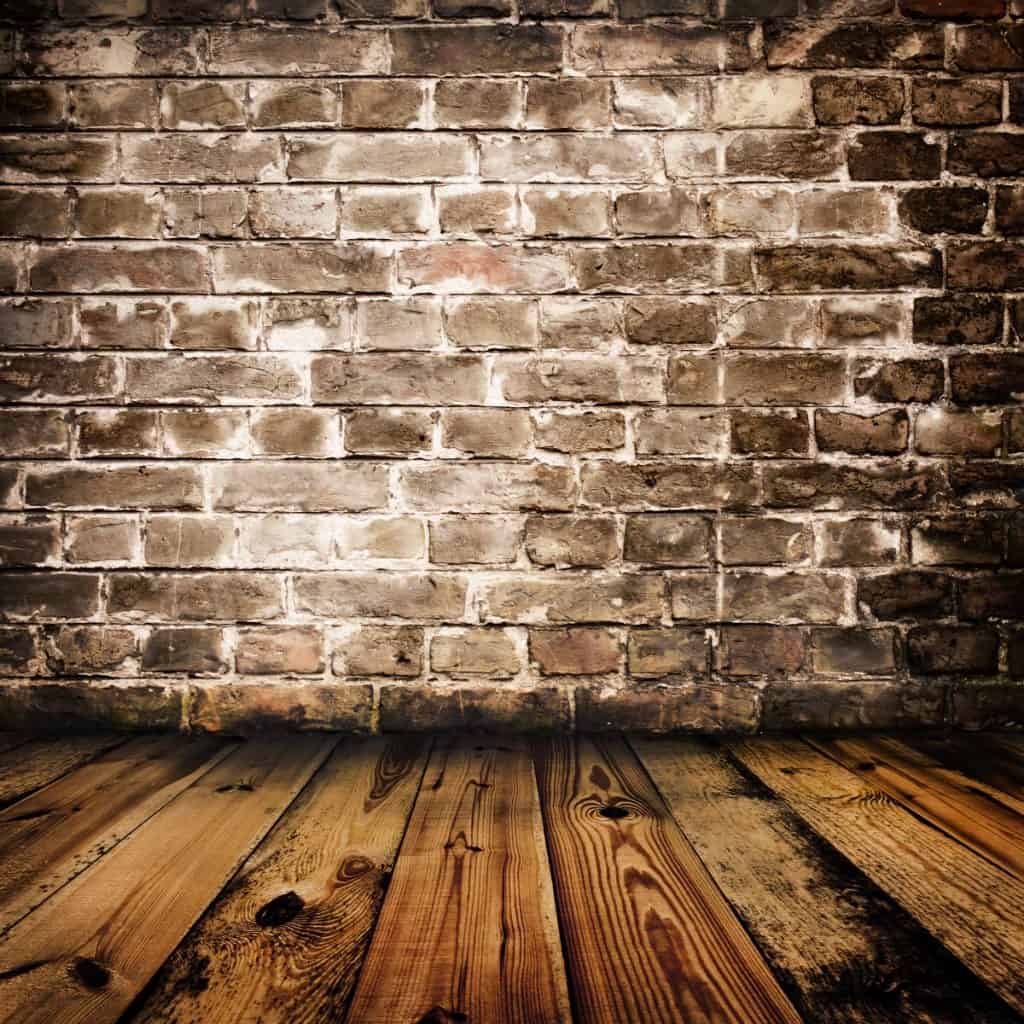 Brick Wall on Top of Wooden Floor