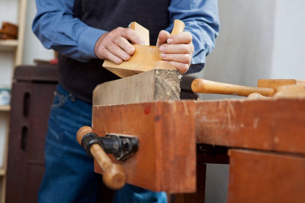 Man Using a Planer on Wood